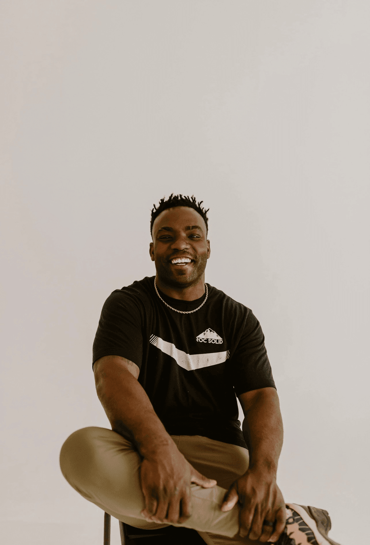 Coach Ben Birmingham, founder of Roc Solid Training, sitting and smiling in Edmond, OK